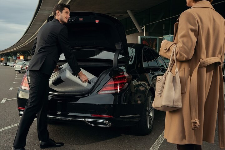 Travellers with suitcases heading for the rail connection at Paris Charles de Gaulle Airport