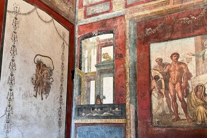 Excavated street in Pompeii with basalt paving and Mount Vesuvius on the skyline