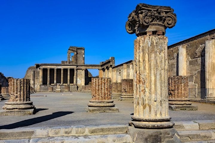 Excavated street in Pompeii with basalt paving and Vesuvius on the skyline
